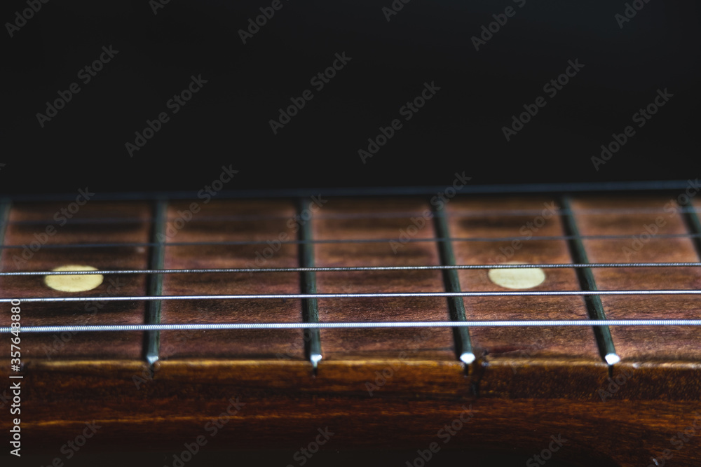 Guitar on black background close-up Guitar on black background close-up
