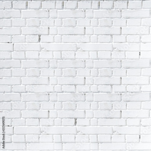 The brick wall is painted with white paint. White brick background. Square orientation. Neutral background, texture of an old white brick wall.