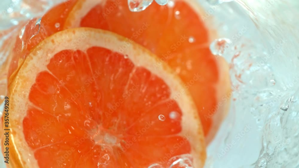 Super Slow Motion Shot of Falling Grapefruit Slices into Water Vortex at 1000fps. Super Slow Motion Shot of Falling Grapefruit Slices into Water Vortex at 1000fps.