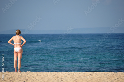 Woman enjoying blue sky and beach