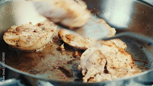 Delicious chicken steaks fried in a pan.