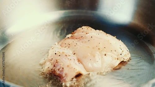 Delicious chicken steaks fried in a pan.