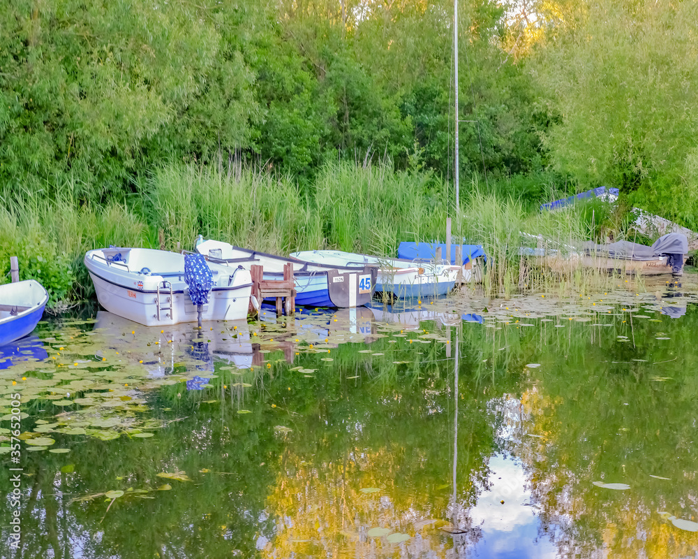 1 Small pleasure boats moored in the staithe at Barton Turf in the Norfolk Broads 1 Small pleasure boats moored in the staithe at Barton Turf in the Norfolk Broads