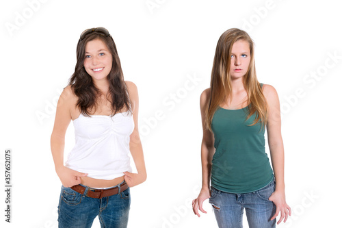 Portraits of two beautiful young women wearing  blue jeans and top, isolated on white studio background