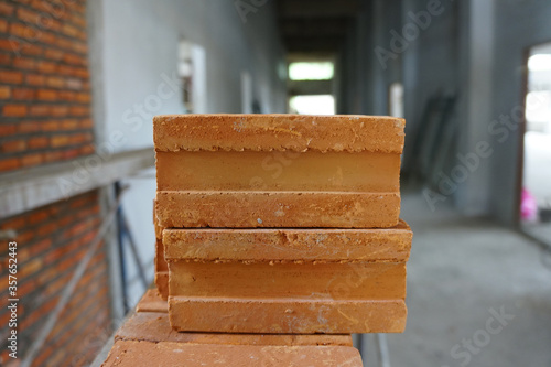 red bricks on construcktion site. The most popular construction bricks of all time. The main components are clay  sand or rice husk  ashes and water. They are durable and strong.