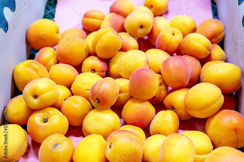 Fresh organic apricots on supermarkets shelf. Healthy food concept.