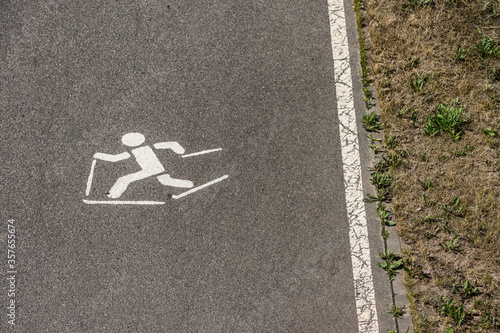 Sign roller ski track on asphalt