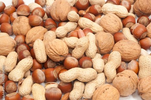 scatterd hazelnuts walnuts pistchios and peanuts photo