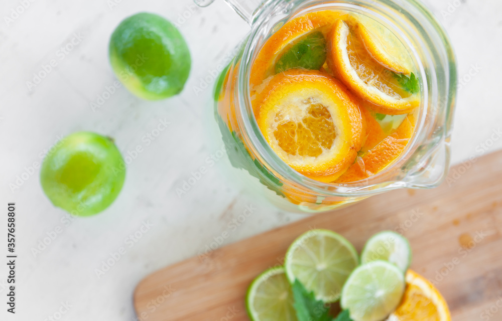 lime, mint and orange lemonade,on an old wooden table, a refreshing drink in the hot summer. Cooling, pleasant taste. Ingredients, homemade recipe lime, mint and orange lemonade,on an old wooden table, a refreshing drink in the hot summer. Cooling, pleasant taste. Ingredients, homemade recipe