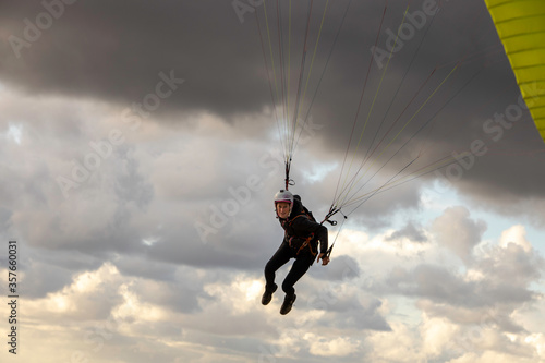woman flying the paraglider alone in the sky