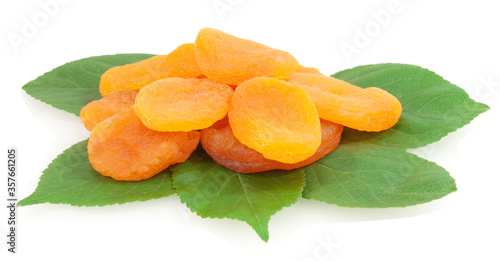 dried apricots on green leaves isolated on white background photo