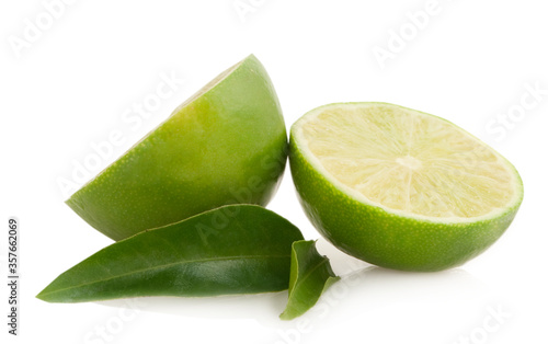 half limes with green leaves ioslated on white background photo