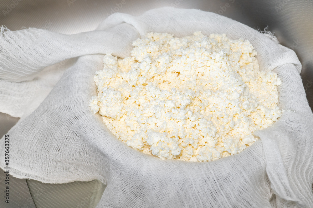 Cooking cottage cheese at home. Natural rustic cottage cheese on gauze. Homemade curd