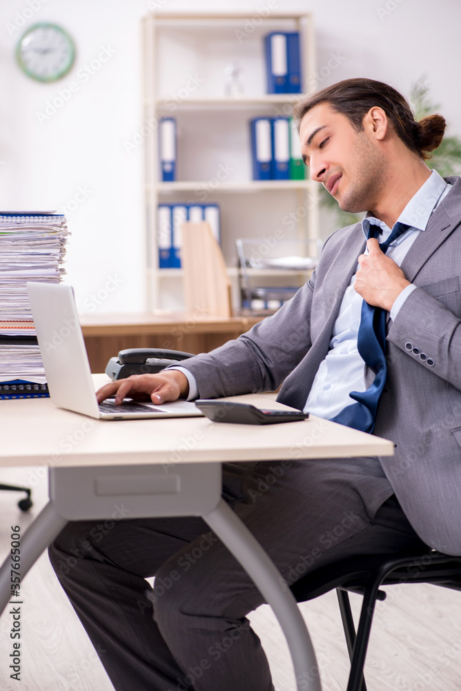 Young male businessman unhappy with excessive work Young male businessman unhappy with excessive work