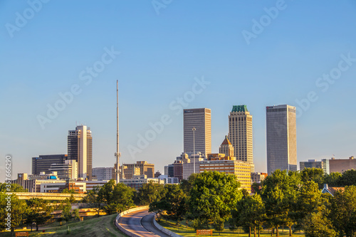 06-14-2020 Tulsa USA - View of downtown skyline from east in early morning with sun reflecting off historical art deco and modern buildings photo