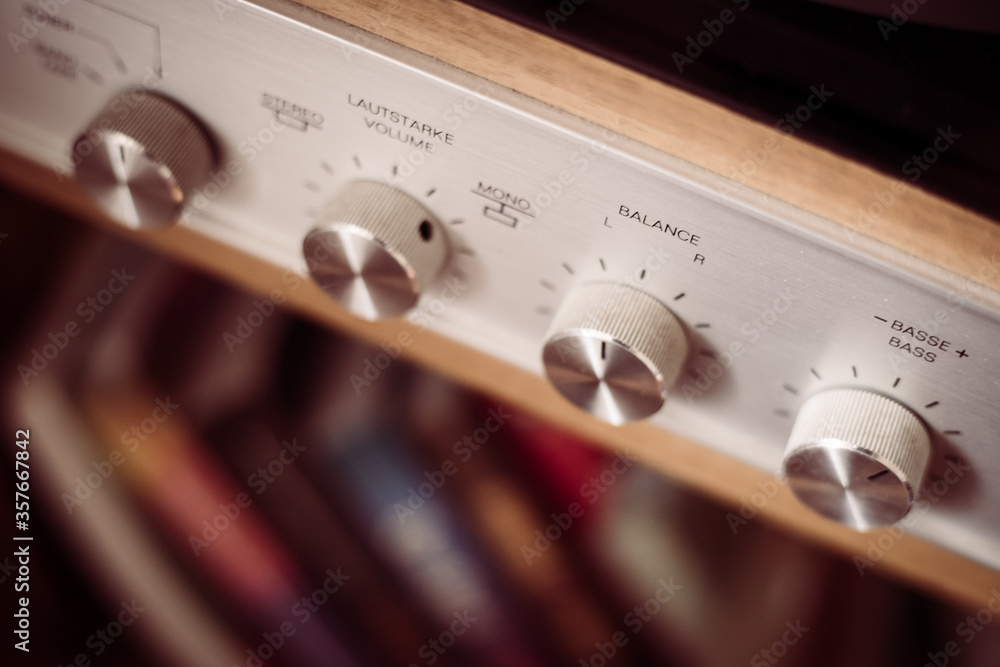Fototapeta premium Silver wooden vintage amplifier: Close up of control knobs