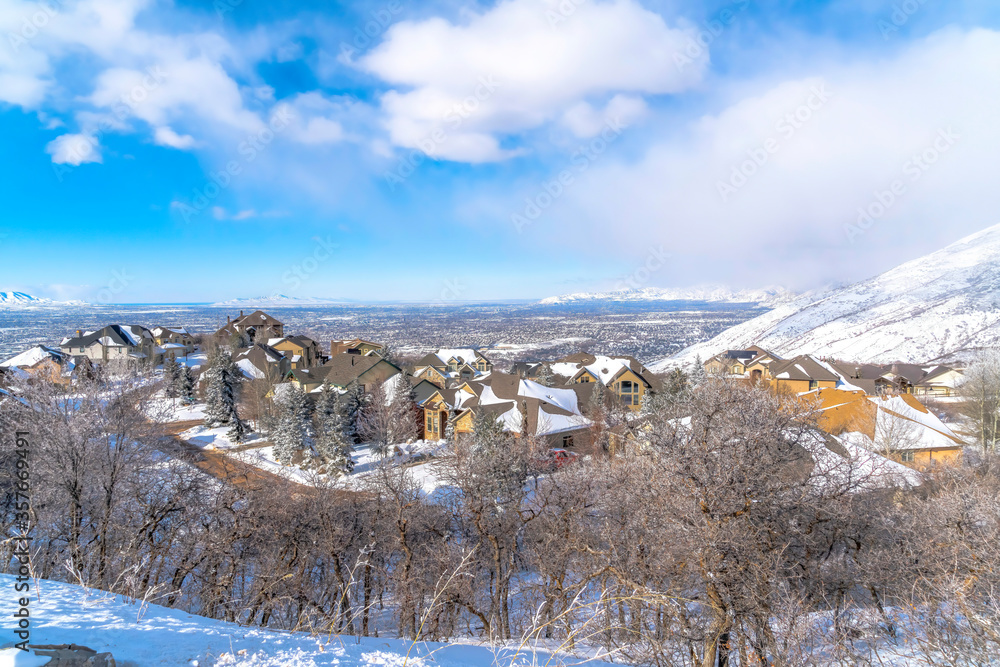 Wasatch Mountains in winter with homes on a neighborhood amid nature scenery