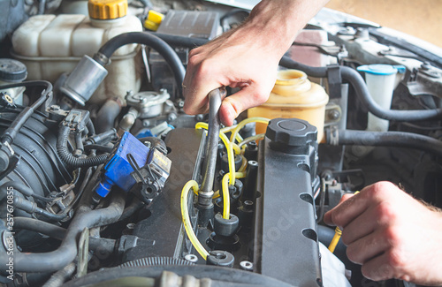 Auto mechanic hand with socket wrench. Car repair and maintenance. Close-up.