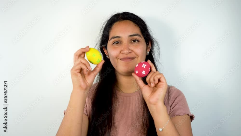 Caucasian young girl with pink shirt holding two easter eggs Caucasian young girl with pink shirt holding two easter eggs