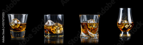 Set of four glass of whiskey with cube ice on black background