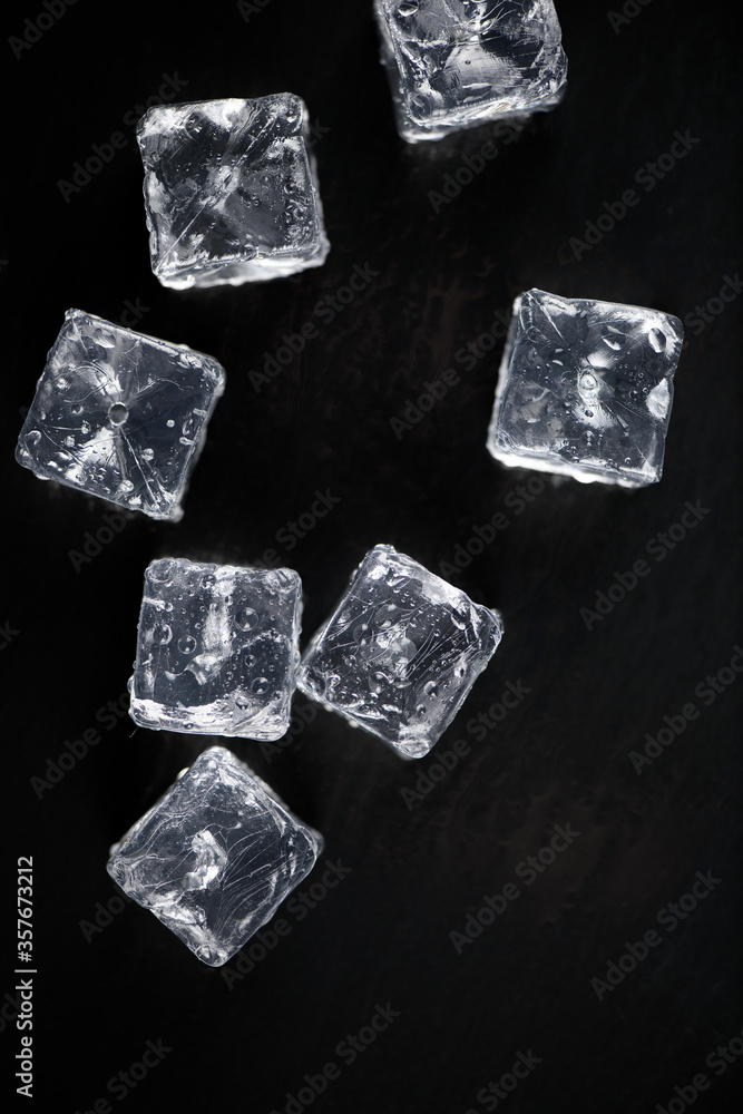Ice cubes reflection on black table background Ice cubes reflection on black table background