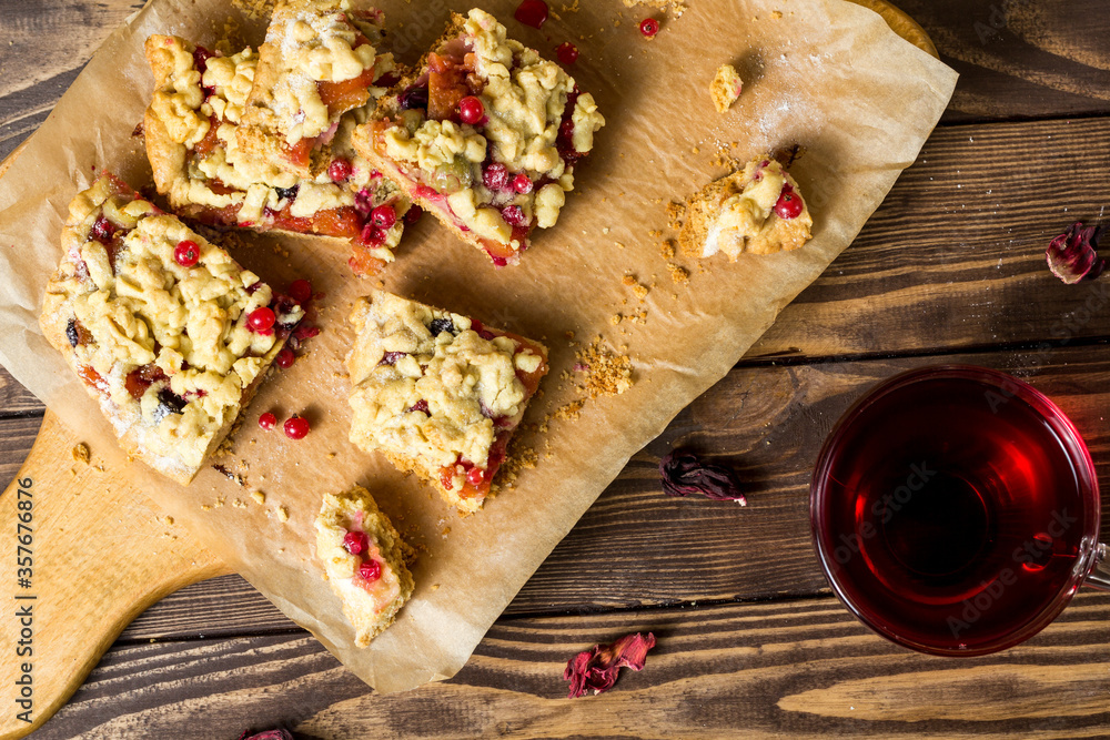 tasty breakfast. sliced homemade grated pie with berries on a wooden board. tasty breakfast. sliced homemade grated pie with berries on a wooden board.