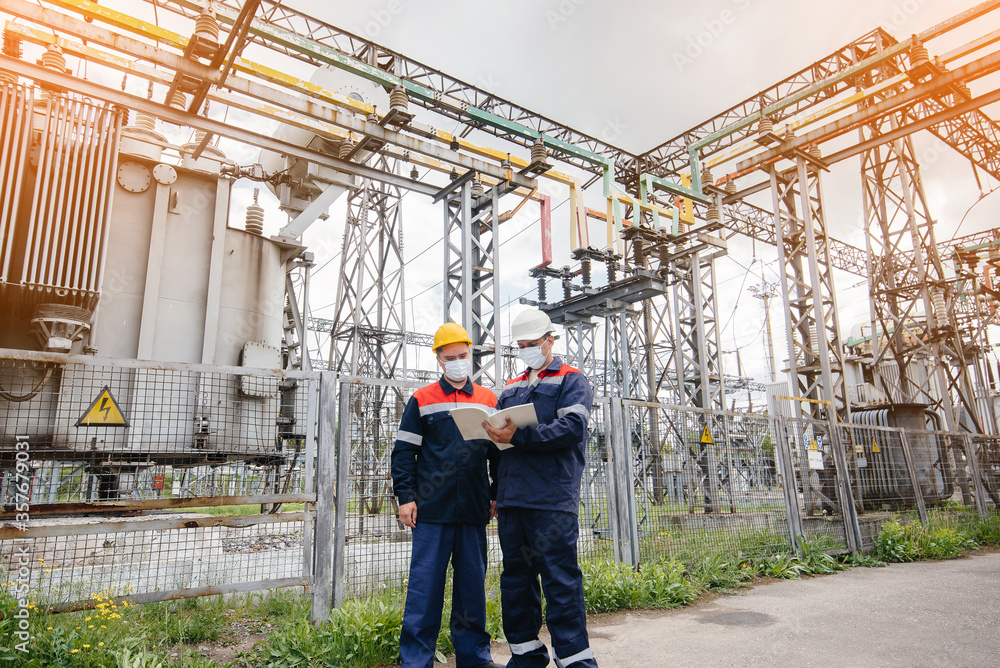 custom made wallpaper toronto digitalEngineers electrical substations conduct a survey of modern high-voltage equipment in the mask at the time of pandemia in the evening. Energy. Industry