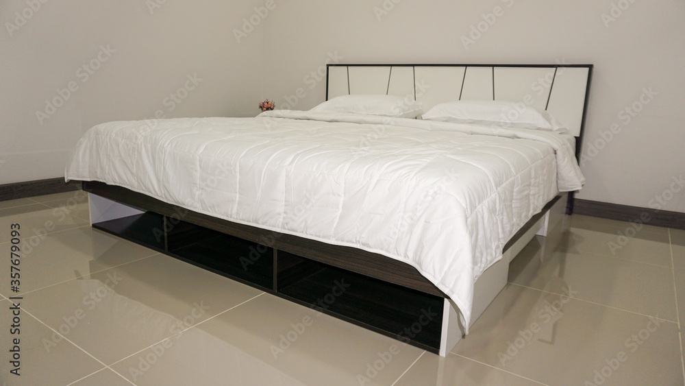 Fototapeta premium King size or Queen size bed with covers, duvet and pillows. Decorated bedroom furniture with walls, windows and curtains. Estate house gallery for sale equipped with furniture.