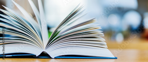Open book lying on the table in the library