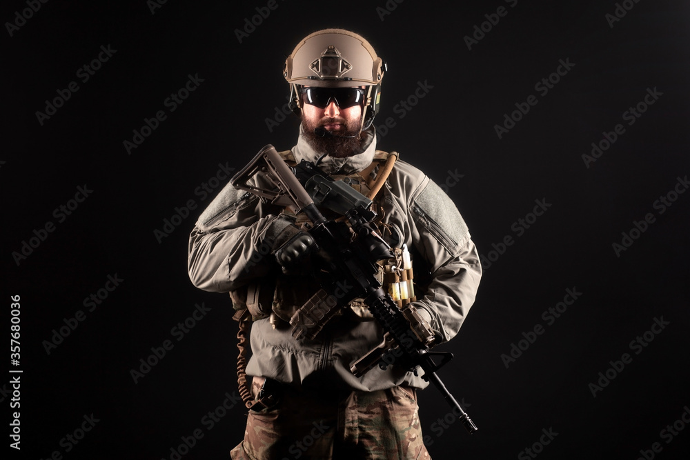 portrait of special forces in a military uniform with weapons at night, elite troops, counter terrorist against a dark background portrait of special forces in a military uniform with weapons at night, elite troops, counter terrorist against a dark background