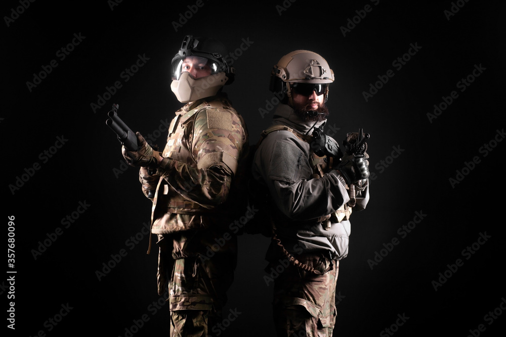 American special forces. two rangers in uniform with weapons stand together against a black background, portrait of two soldiers