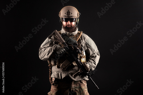 portrait of special forces in a military uniform with weapons at night, elite troops, counter terrorist against a dark background