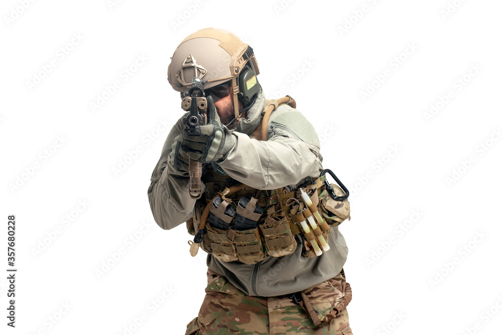 American soldier in uniform and with a rifle aiming and shoots, commando with guns on a white background American soldier in uniform and with a rifle aiming and shoots, commando with guns on a white background