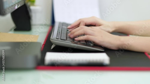 Hand of woman working on computer at home-office, close up of female hands typing on keyboard.