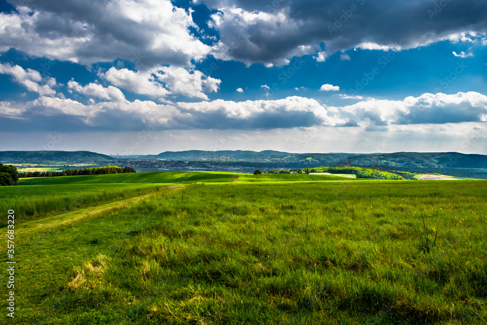 Rural Landscape With Sunlit Clouds In Front Of The Skyline Of Vienna In Austria Rural Landscape With Sunlit Clouds In Front Of The Skyline Of Vienna In Austria