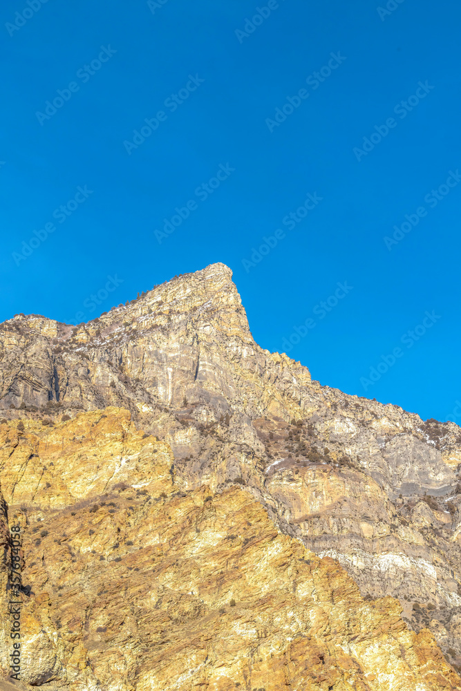 Peak of a rocky mountain with clear blue sky background in Provo Canyon Utah