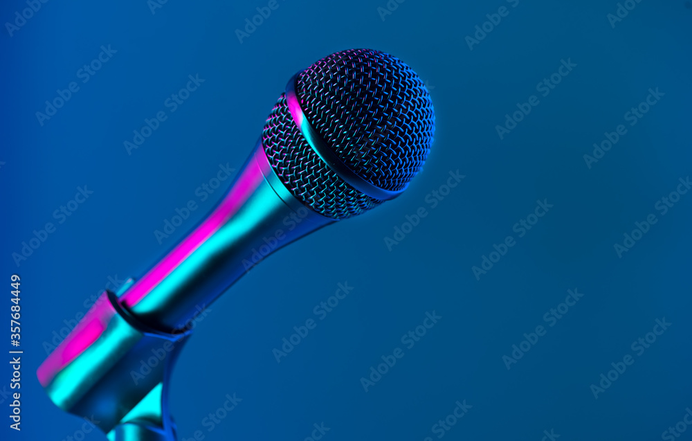 Microphone on stage close-up. Mic closeup. Karaoke, night club, bar. Music  concert. Mike over colorful lights background. Song, music concept Stock  Photo | Adobe Stock