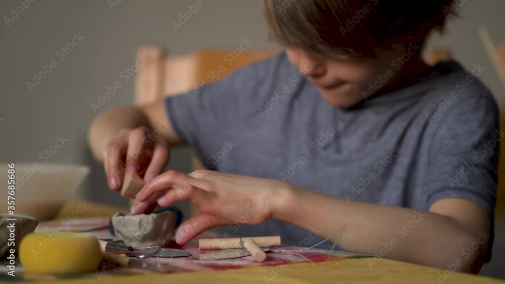 The manufacture of ceramics. Little boy sculpts from clay. The manufacture of ceramics. Little boy sculpts from clay.