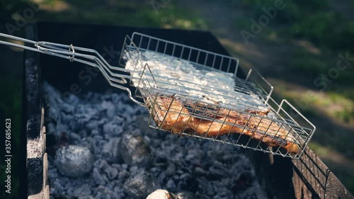 Wallpaper Mural Grilled fish foil in open foil. Delicious fish steak. Cooking on bbq grill. Close up grilling fillet with black pepper on charcoal grill. Preparing fish bbq at picnic outdoor. Smoke. Torontodigital.ca