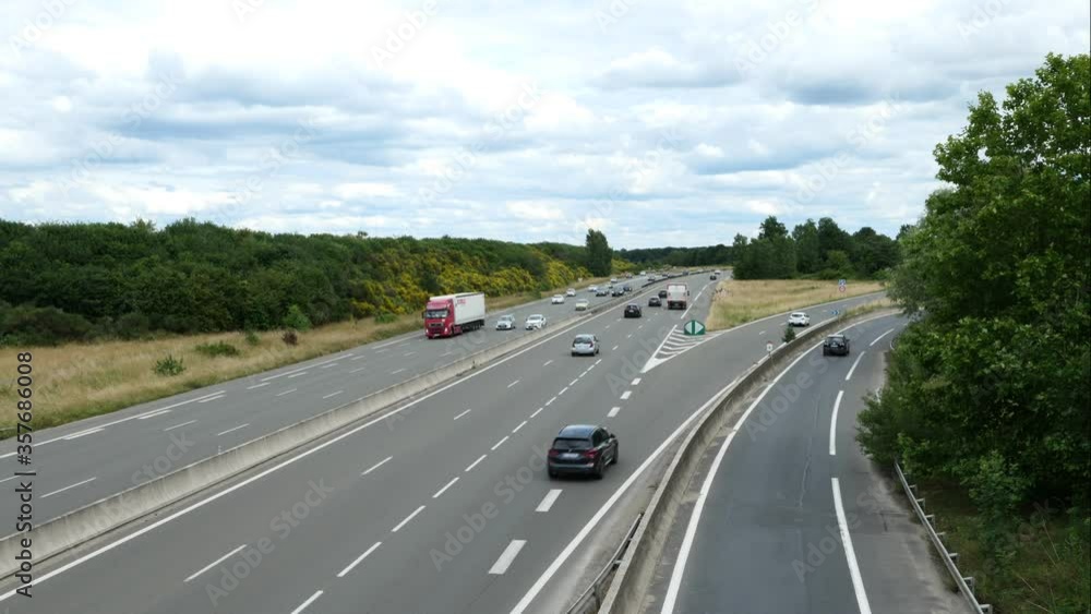 Timelapse of cars on a highway during the day. Fast movement of accelerated vehicles on the road as seen from a bridge. Timelapse of cars on a highway during the day. Fast movement of accelerated vehicles on the road as seen from a bridge.