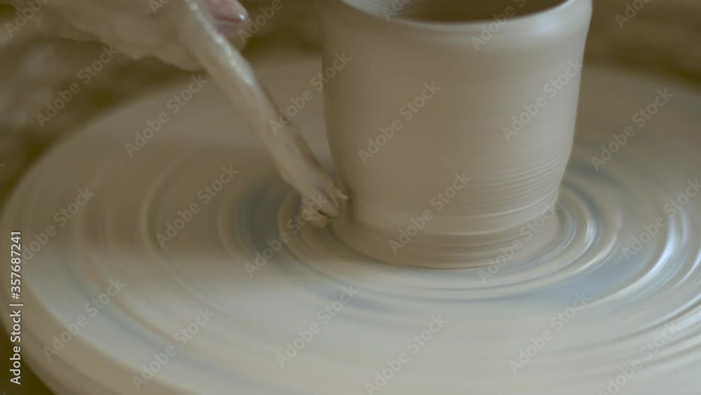 The manufacture of ceramics. Man sculpts from clay on pottery wheel. The manufacture of ceramics. Man sculpts from clay on pottery wheel.
