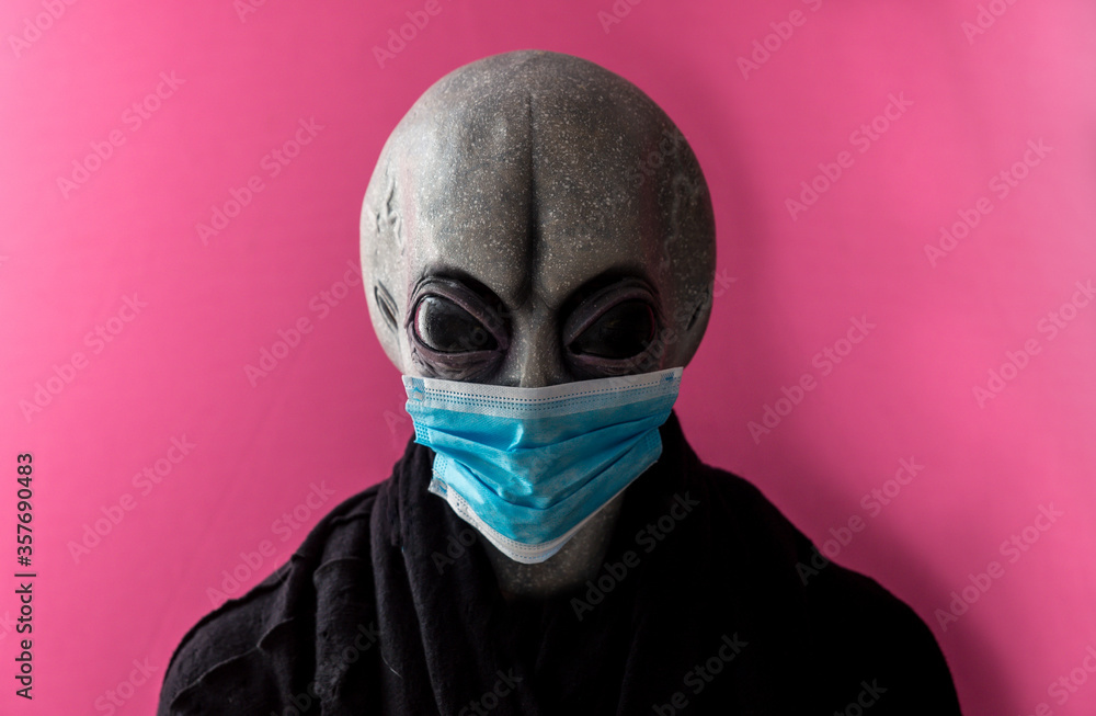 Alien creature with medical mask. Alternative concept about coronavirus Alien creature with medical mask. Alternative concept about coronavirus
