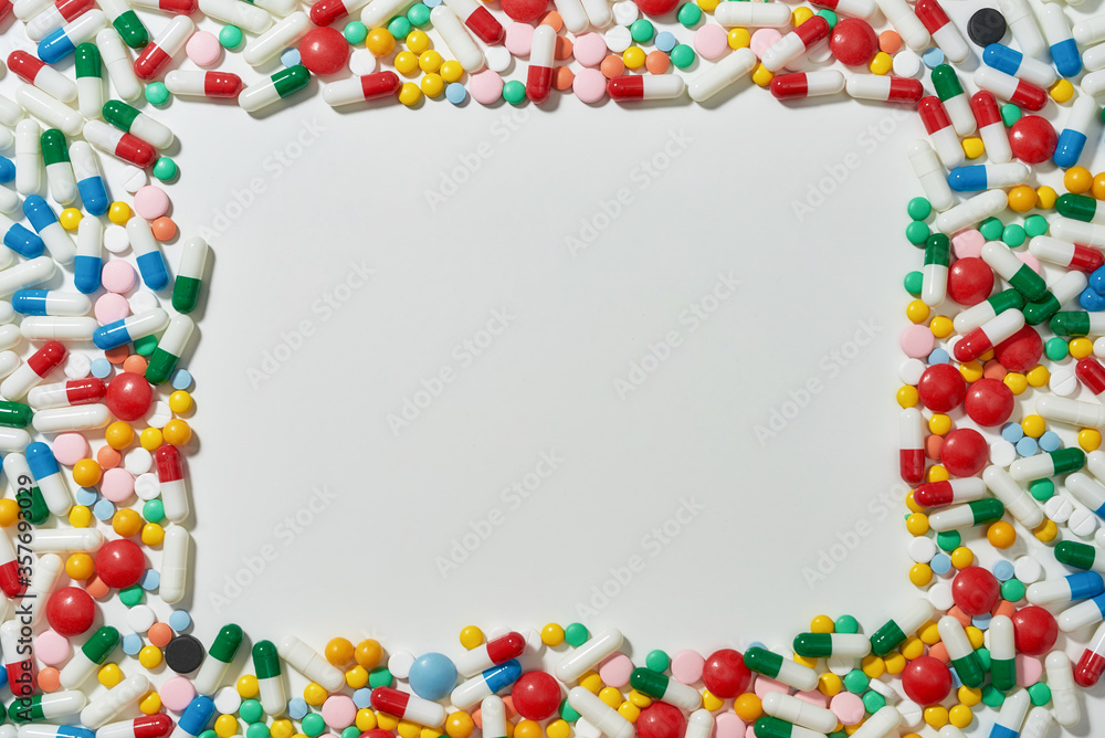 Different pills, capsules scattered in the shape of rectangle over white background. Health care, vitamins and treatment concept