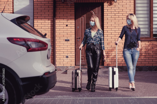 Two young women are going to travel by car