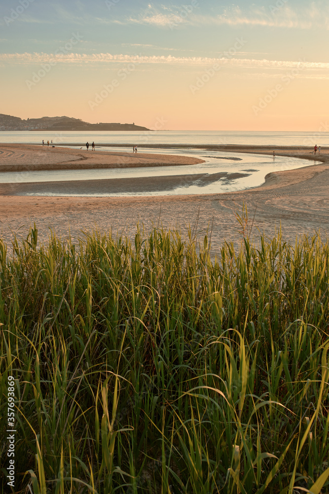 Mouth of a small river on the beach at sunset Mouth of a small river on the beach at sunset