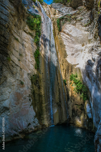 Waterfall running through large rocks in Lefkada, Greece