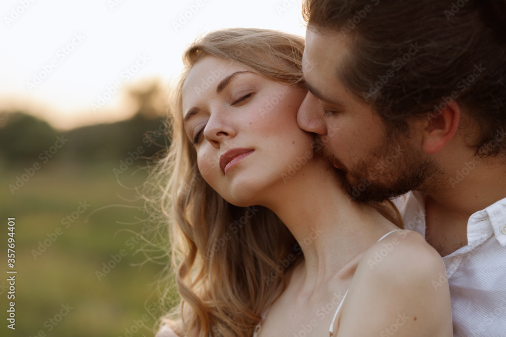 The guy kisses the girl in the neck. close-up portrait The guy kisses the girl in the neck. close-up portrait