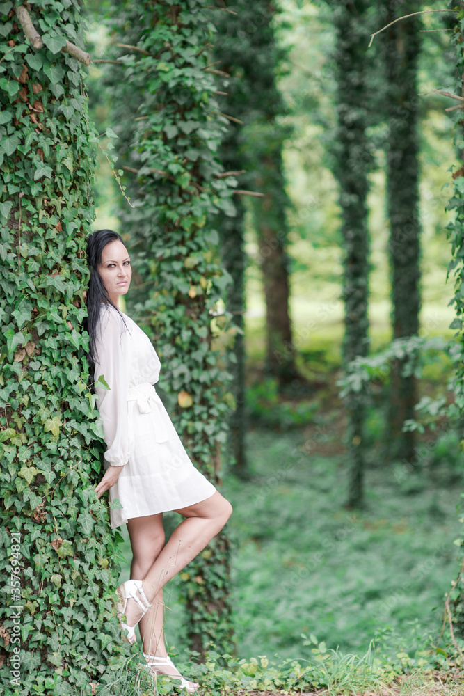 beautiful black haired girl posing in the park beautiful black haired girl posing in the park
