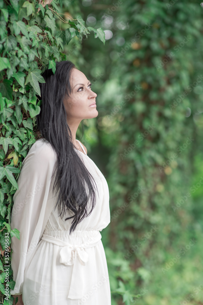beautiful black haired girl posing in the park beautiful black haired girl posing in the park