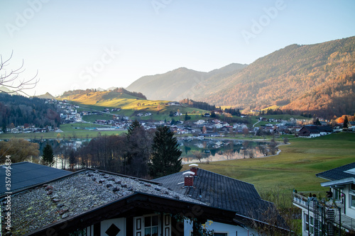 Traditional rural landscape with houses, fields and mountains in Austria.